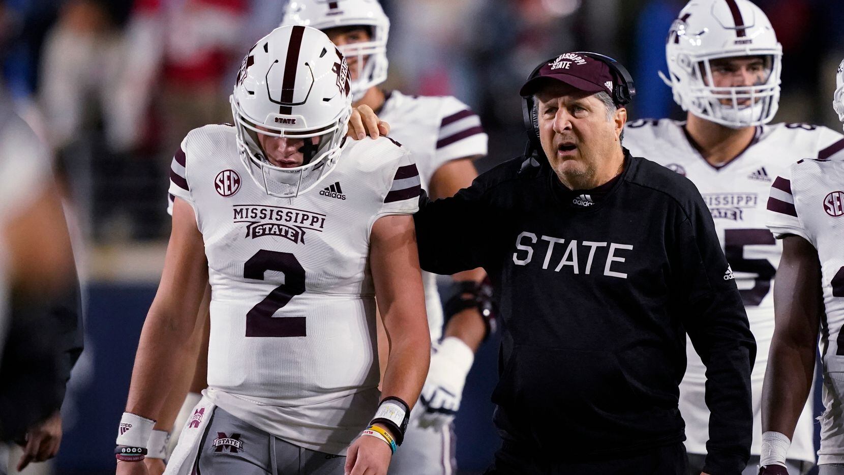 Mississippi State coach Mike Leach confers with quarterback Will Rogers (2) during the first...