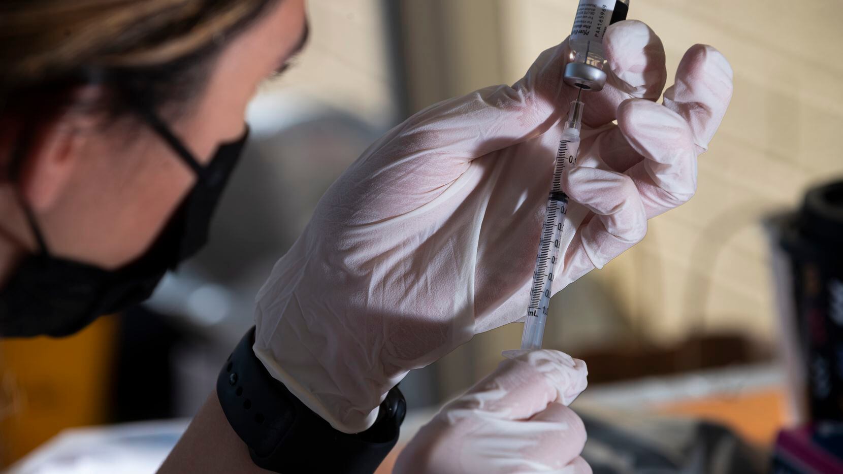 A medical professional prepared a Pfizer vaccine during a pop-up COVID-19 vaccine clinic...