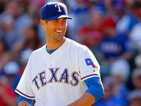 Texas Rangers starting pitcher Cole Hamels (35) laughs at  home plate umpire Jim Joyce after...