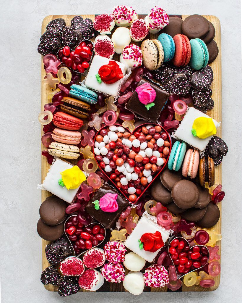 Petits fours, macarons, jelly beans and more comprise a Valentine's Day dessert board