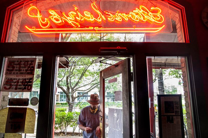 Owner Tom Garrison prepared to lock up his Oak Lawn bar, the Stoneleigh P, on Friday.