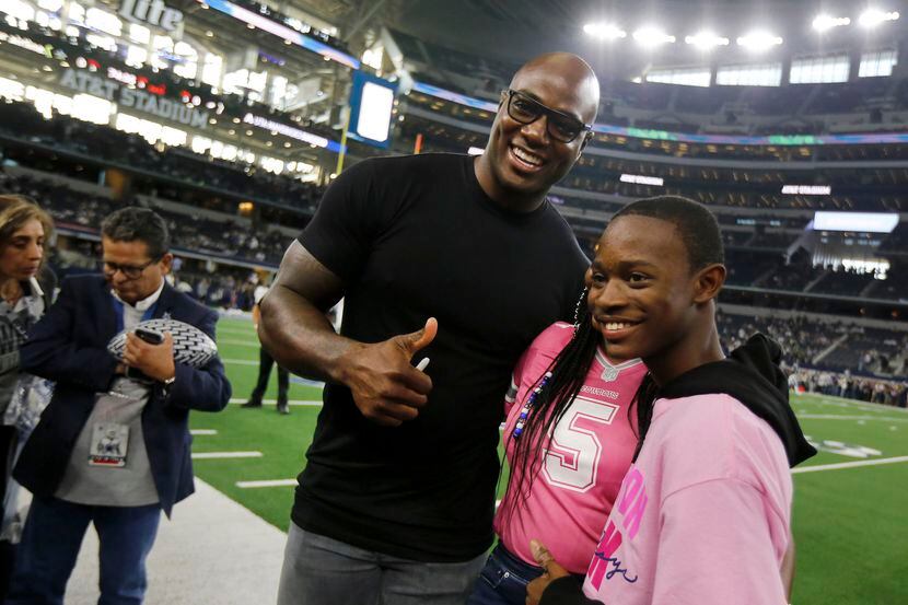 Former Dallas Cowboys football player DeMarcus Ware takes photos with fans during pregame...