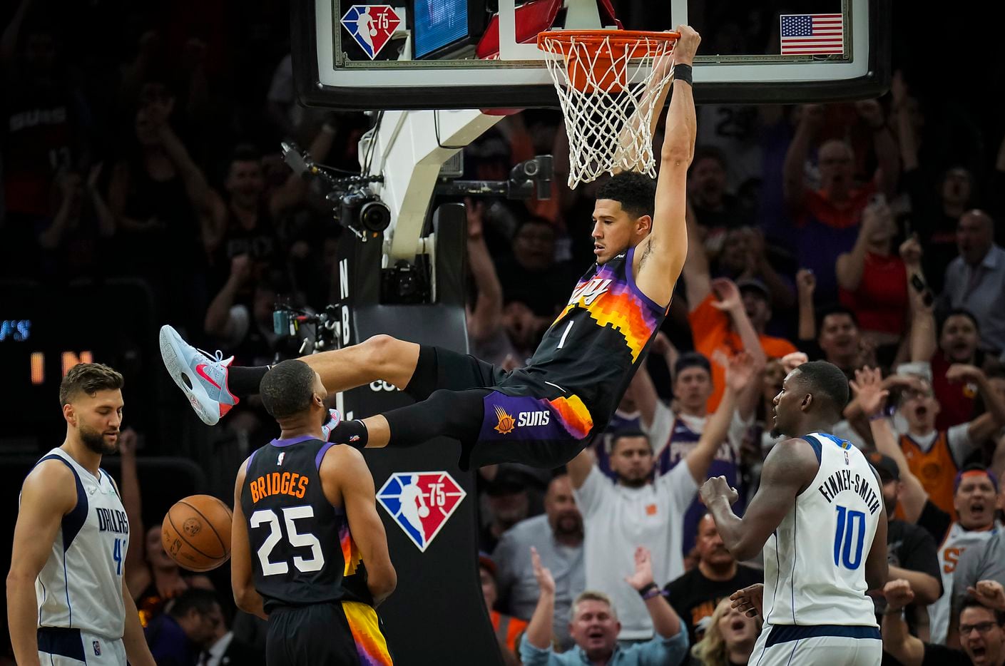 Phoenix Suns guard Devin Booker (1) dunks the ball past Dallas Mavericks forward Dorian...