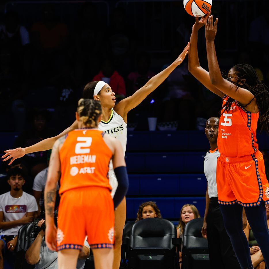 Dallas Wings forward Isabelle Harrison (20) tries to block a shot from Connecticut Sun...