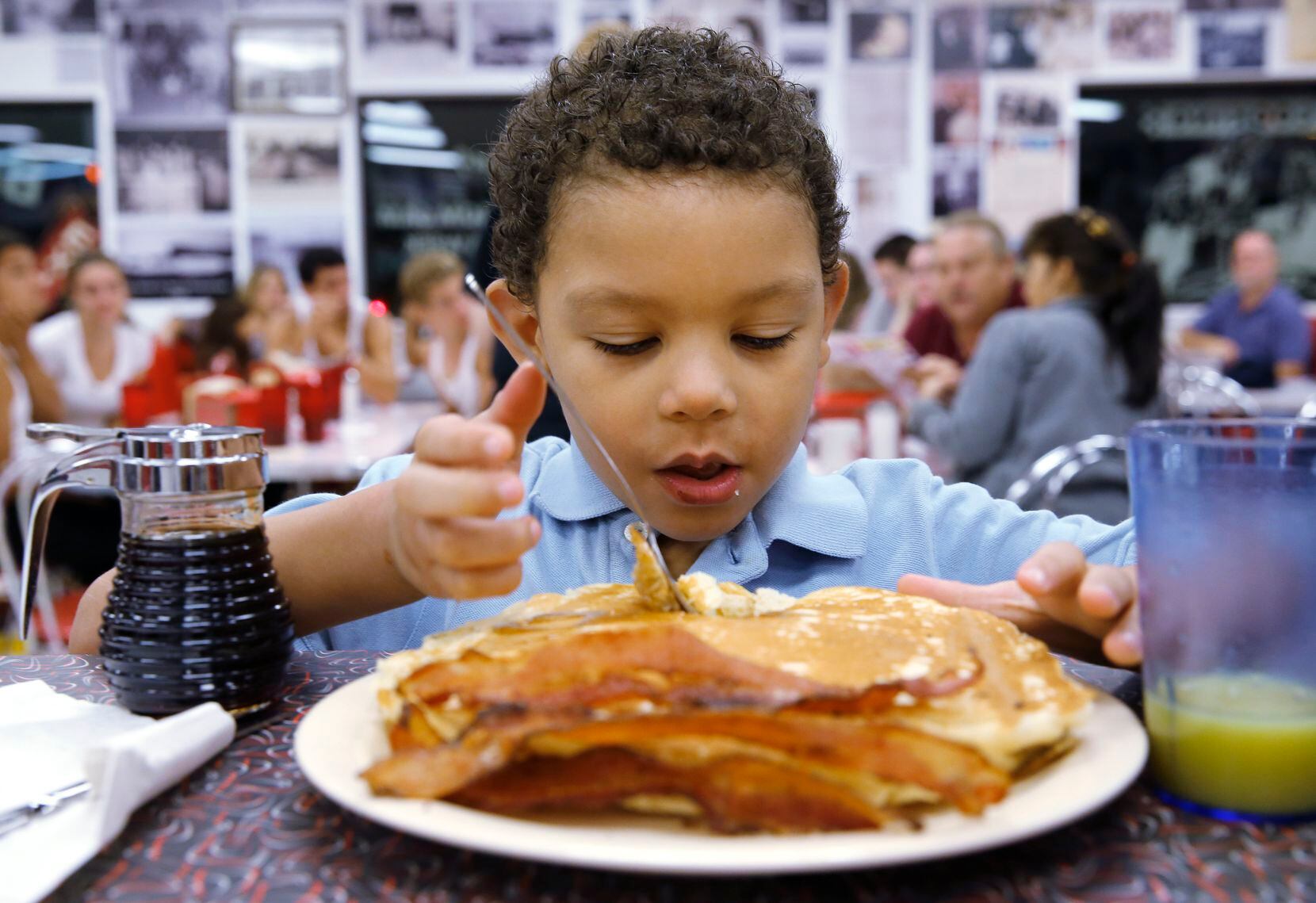 In this 2014 file photo, Brian Armes, 5, gets ready to eat a big stack of pancakes at Big...