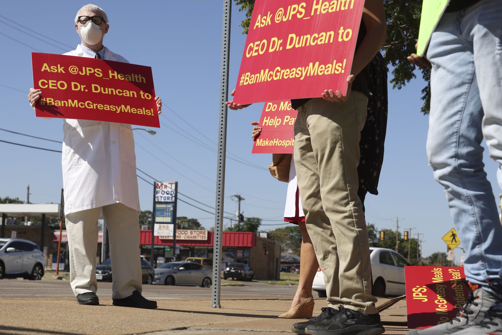 Dr. John Pippin and others gather to protest against the McDonalds inside John Peter Smith...