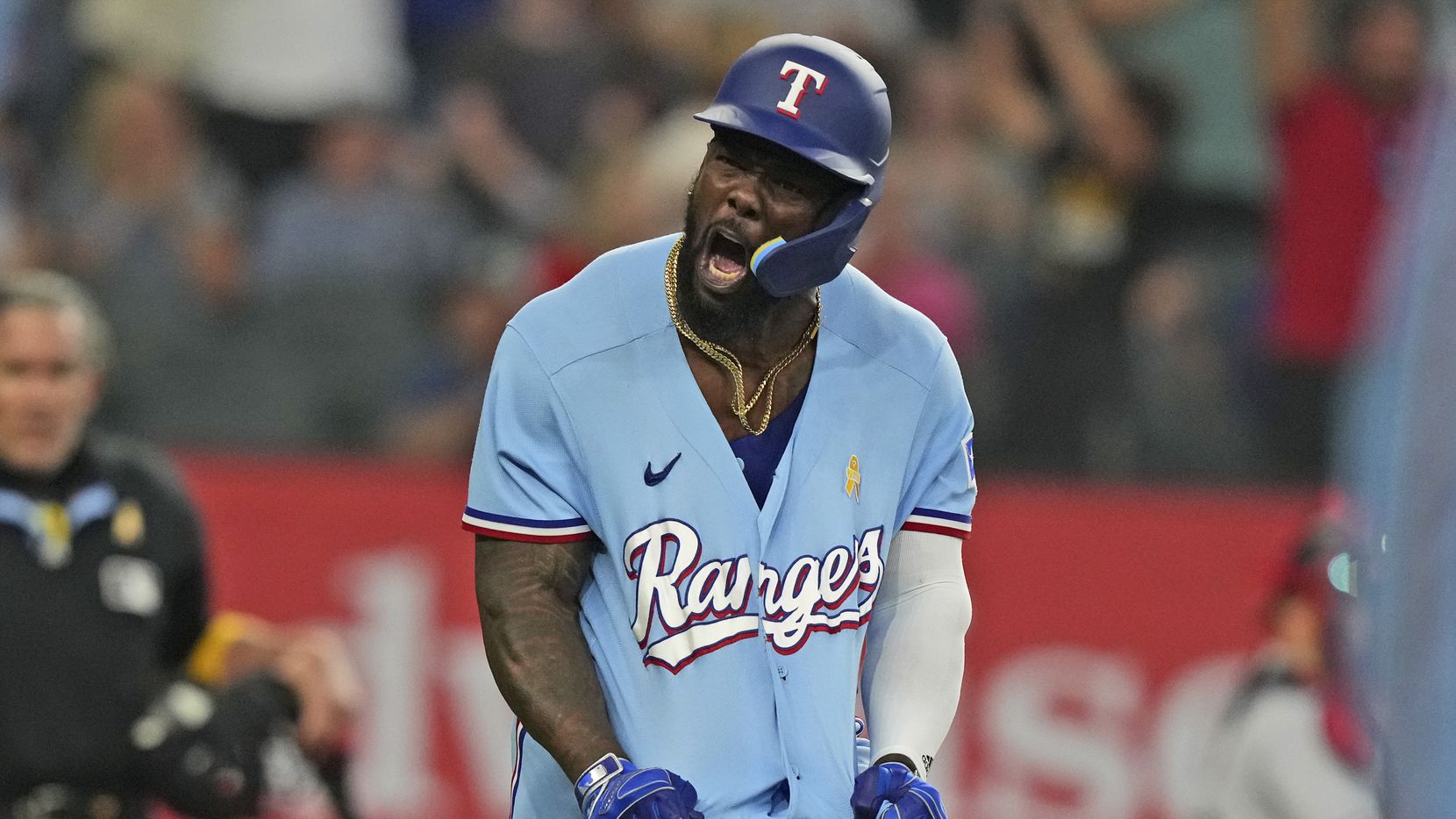 Texas Rangers' Adolis Garcia reacts to hitting a solo home run during the ninth inning of a...