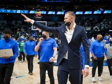 Dallas Mavericks center Kristaps Porzingis waves to fans as he leaves the court following the first half of an NBA basketball game against the Oklahoma City Thunder at American Airlines Center on Wednesday, Feb. 2, 2022, in Dallas.
