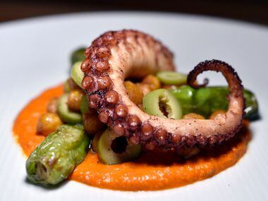 Octopus with chick peas, olives and shishito peppers on romesco sauce, an antipasto at...