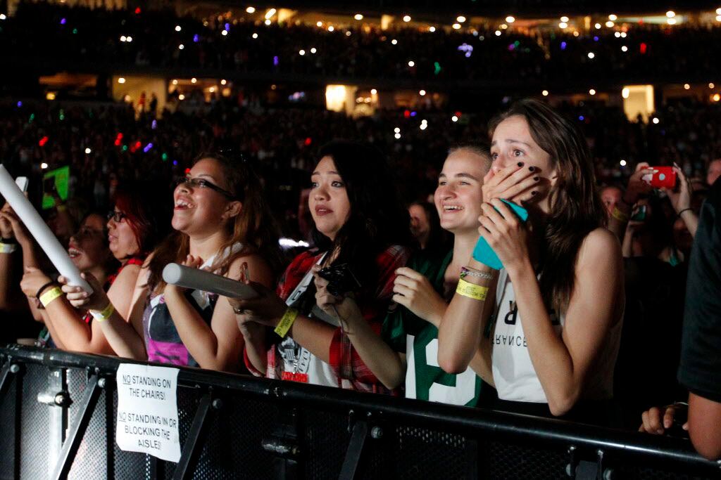 Teen fans react as One Direction comes out on stage at AT&T Stadium in Arlington, TX August...