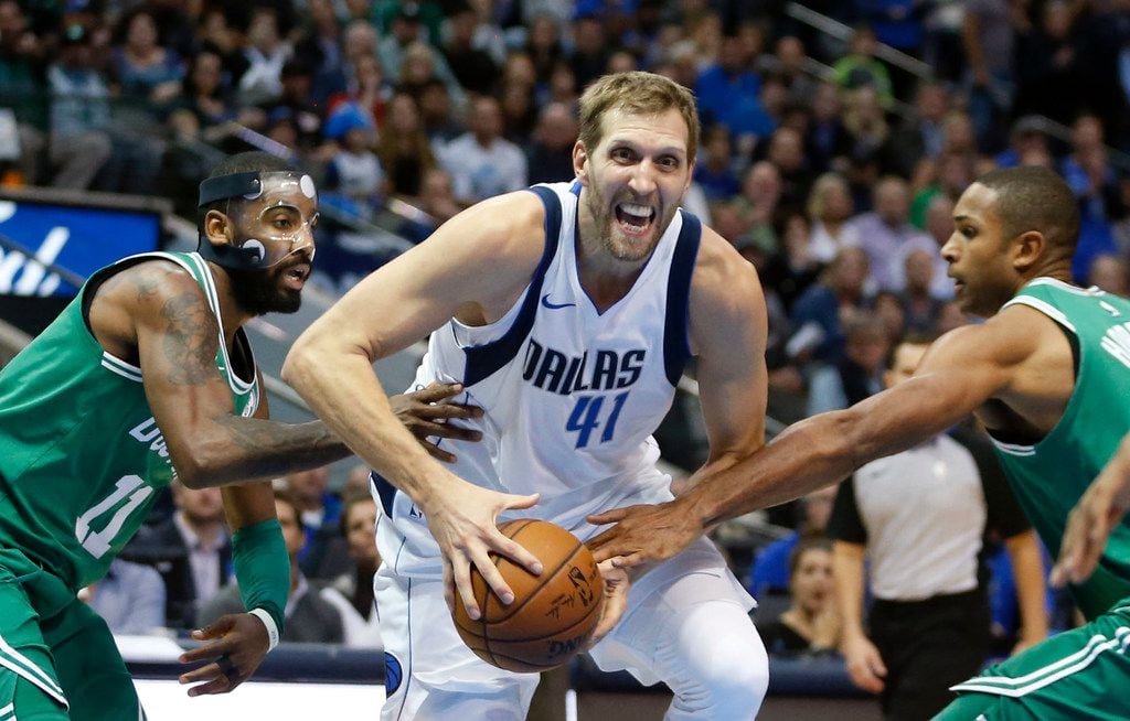 Dallas Mavericks forward Dirk Nowitzki (41) drives past Boston Celtics guard Kyrie Irving...