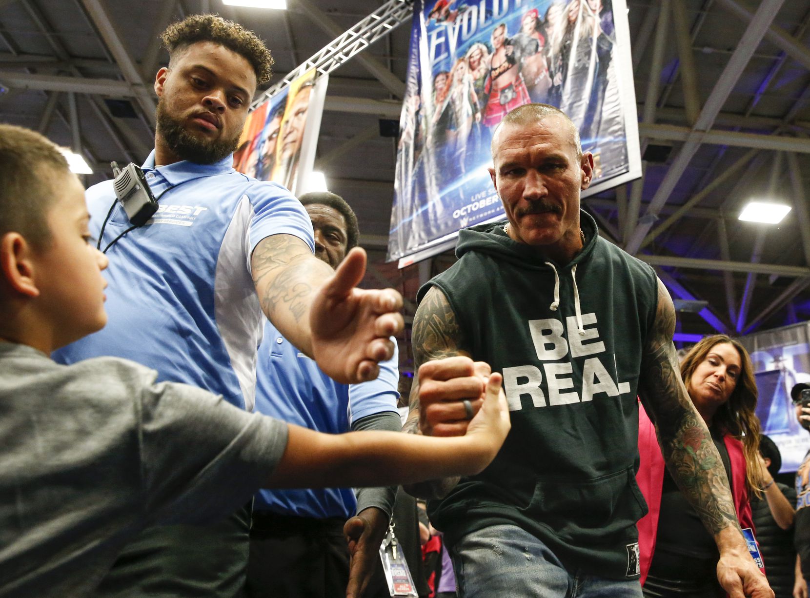Derek Garcia, 6, from Dallas, gets a fist bump from WWE superstar Randy Orton during an...