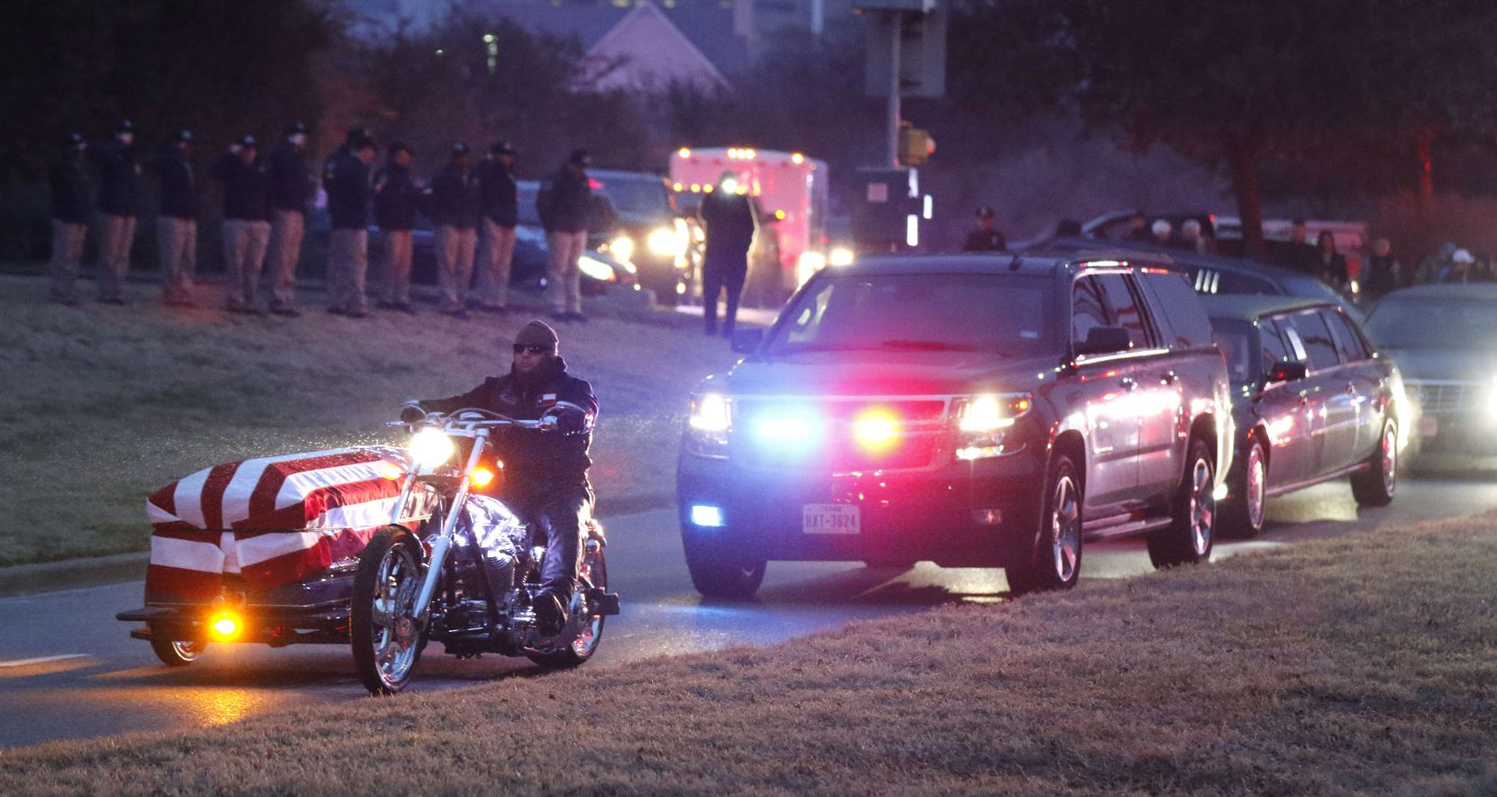 Law enforcement officers salute as a motorcycle carrying Richardson police officer David...