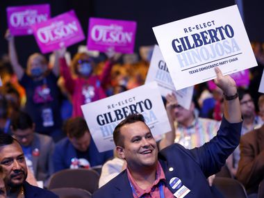 Supporters of incumbent Gilberto Hinojosa and challenger Kim Olson cheer their support...