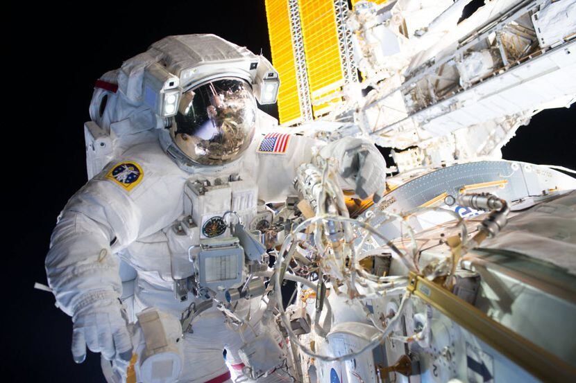 Expedition 48 Commander Jeff Williams installs the first of two international docking...