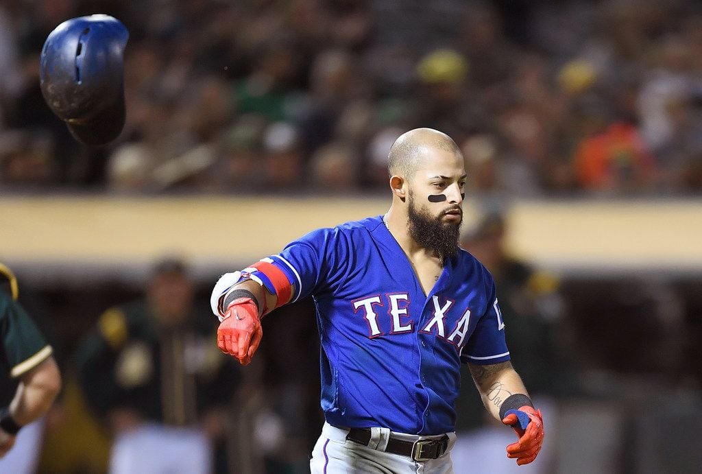 OAKLAND, CA - SEPTEMBER 22:  Rougned Odor #12 of the Texas Rangers reacts by tossing his...