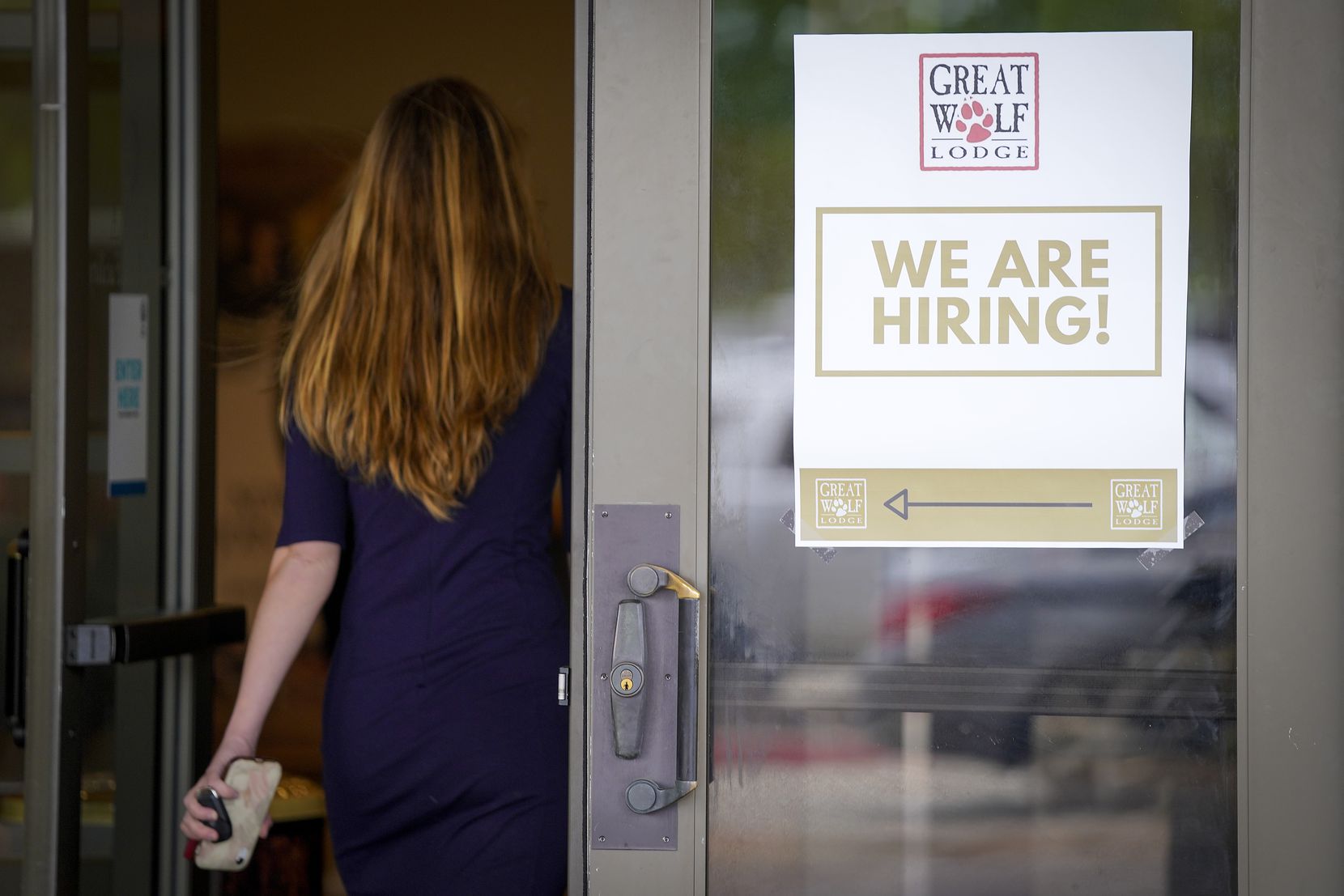 A sign directs job candidates to a hiring event at Great Wolf Lodge Grapevine on May 4. The...