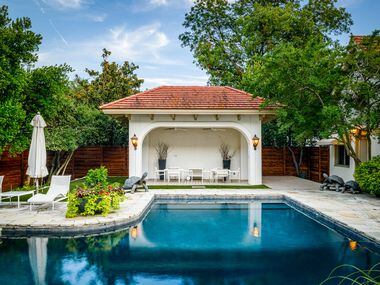 The swimming pool has a lap lane and is surrounded by lounging areas and a small casita.