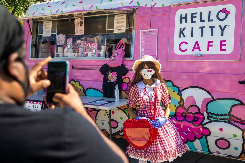 Fans snap a photo in front of the Hello Kitty Cafe truck during a 2020 visit to Frisco.