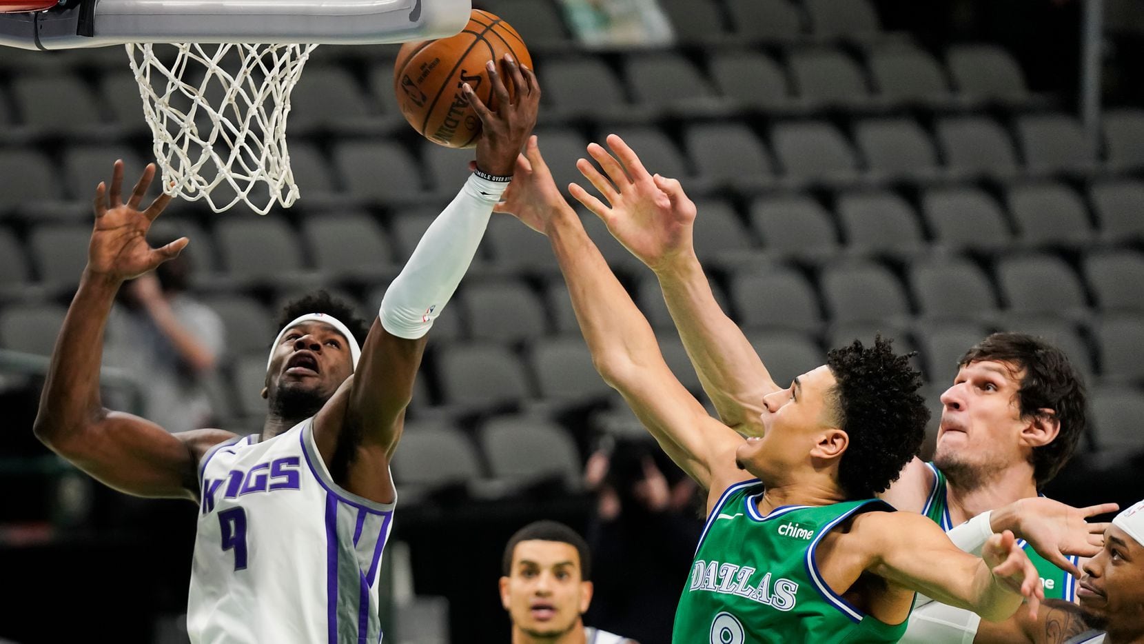 Dallas Mavericks guard Josh Green (8) fights for a rebound against Sacramento Kings guard Terence Davis (9) during the first half of an NBA basketball game at American Airlines Center on Sunday, May 2, 2021, in Dallas.
