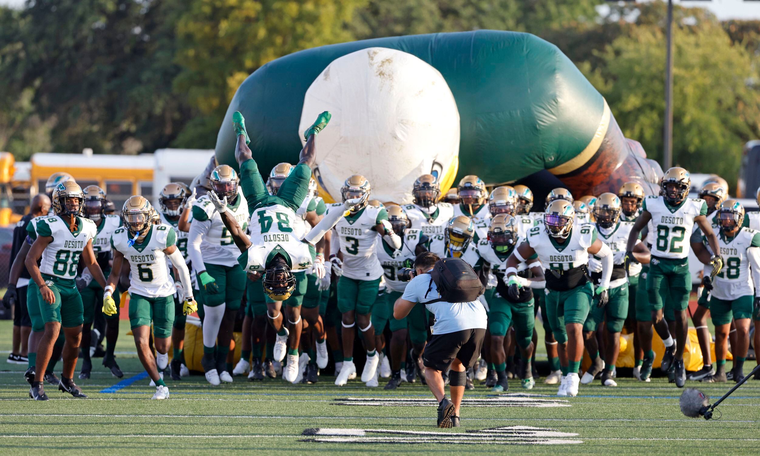 DeSoto senior wide receiver Maquis Wortham (84) flips in front of his team as they take the...