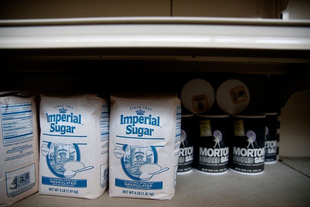 Faded sugar and salt packages still sit on the shelves of the Villasana Food Store, which is...