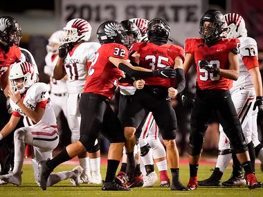 Argyle linebacker Davis Elsey (35) celebrates with linebacker Grant Mirabal (32) and defensive lineman Michael Madrie (58) after sacking Melissa quarterback Sam Fennegan (left) during the first half of Argyle's 48-28 win. (Smiley N. Pool/The Dallas Morning News)