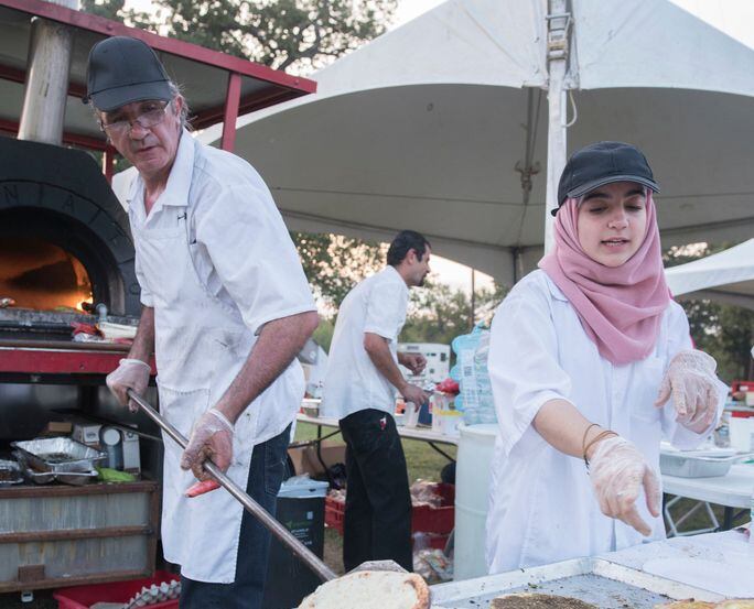 Cheese breads are prepared during the Texas Arab Festival.