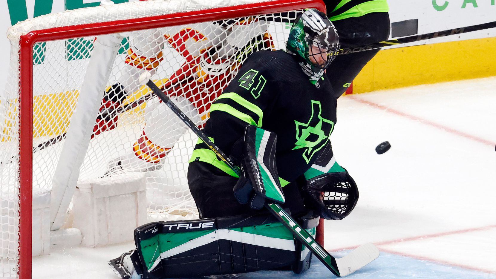 Dallas Stars goaltender Scott Wedgewood (41) stops a Calgary Flames shot during the second...