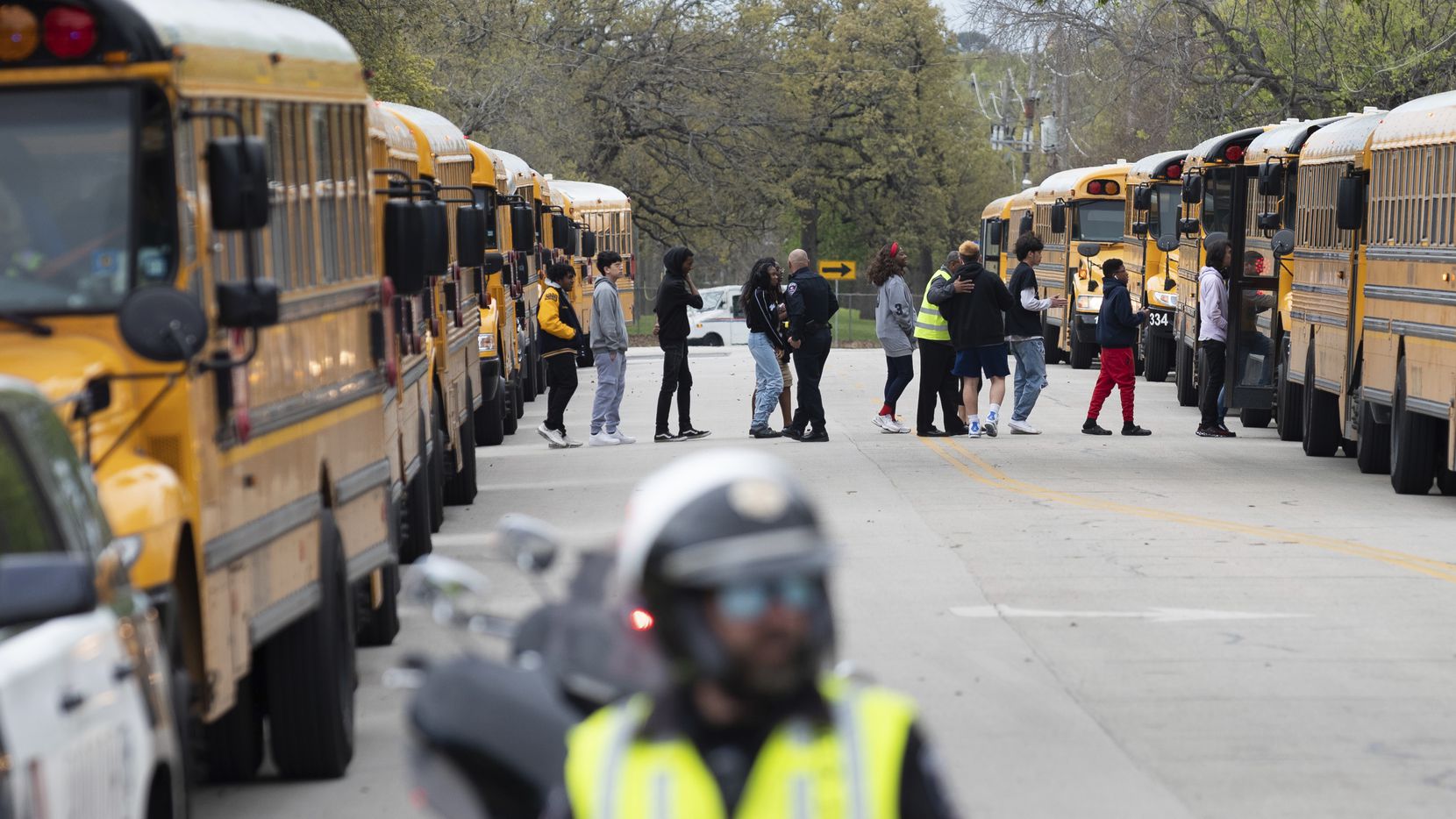 Arlington Police officers block a street as Lamar High School students and faculty are...