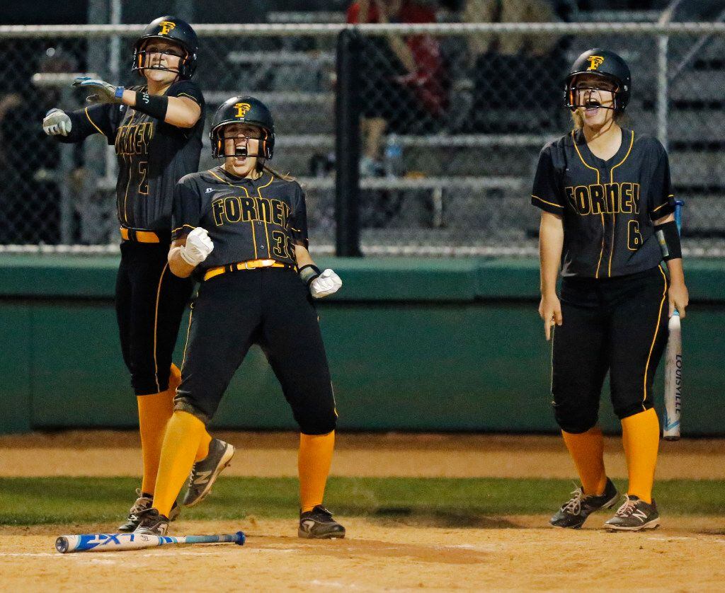 Forney baserunners Savannah DesRochers (2), Caroline Tedder (30) and Emily Galiano (6) celebrate after each crossed the plate in the fourth inning as Lovejoy  hosted Forney in a District 15-5A softball game at Lovejoy on  April 7, 2017.