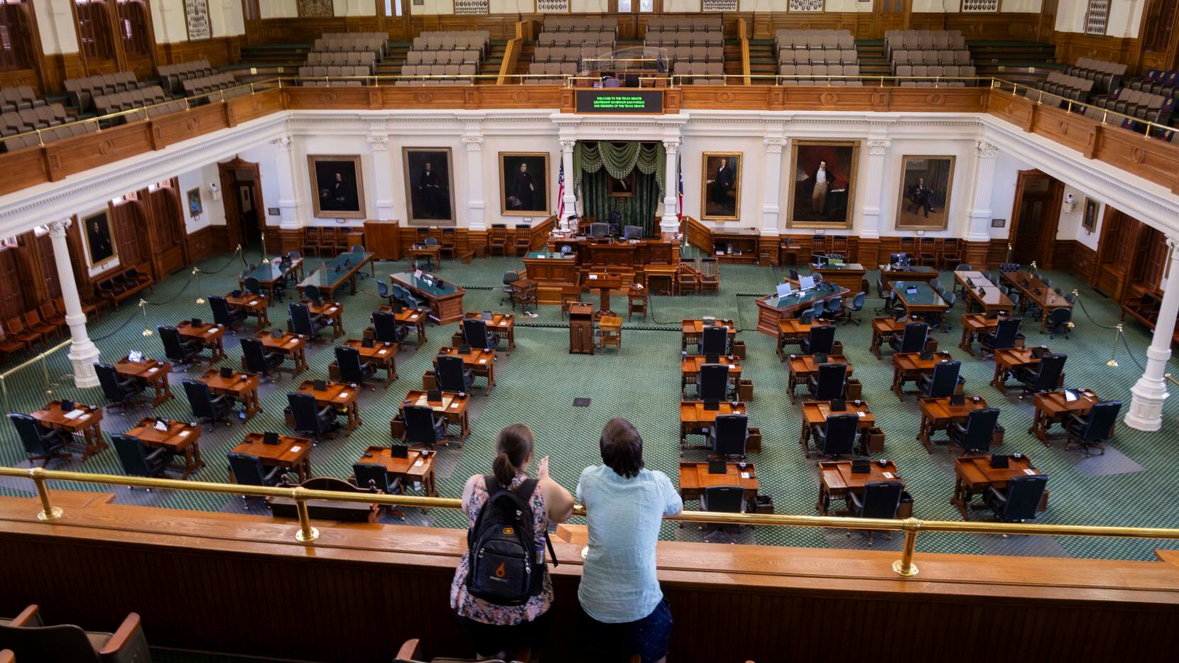 Haley Solomon (left) and Joseph Solomon from Maryland look out from the gallery of the Texas...
