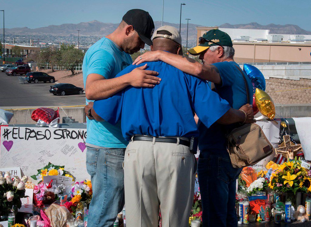 People prayed at the makeshift memorial for victims of the shooting that left a total of 22 people dead at the Cielo Vista Mall Walmart in El Paso on Aug. 7, 2019. 