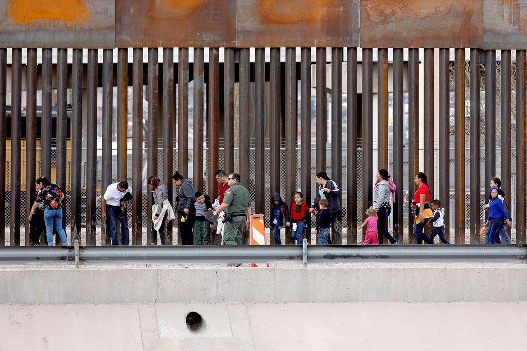 Migrants seeking asylum turn themselves in to U.S. Border Patrol agents on the El Paso side...