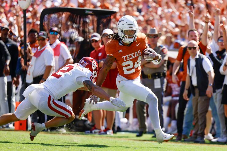 Oklahoma defensive back Billy Bowman Jr. (left) tries to tackle Texas running back Jonathon...