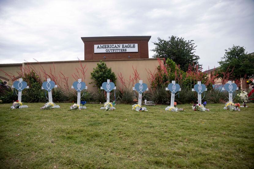 Eight crosses at memorial outside the mall after a mass shooting at Allen Premium Outlets in...