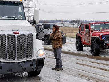 Angel Muniz speaks with a stranded semi-truck driver before members of the Carnales Off Road...