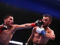 Vergil Oritz Jr. punches by Michael McKinson, Saturday, August 6, 2022, at Dickies Arena in...