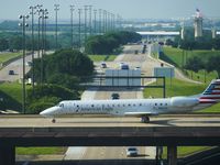 An American Eagle plane taxis on a bridge over International Parkway at DFW Airport on...