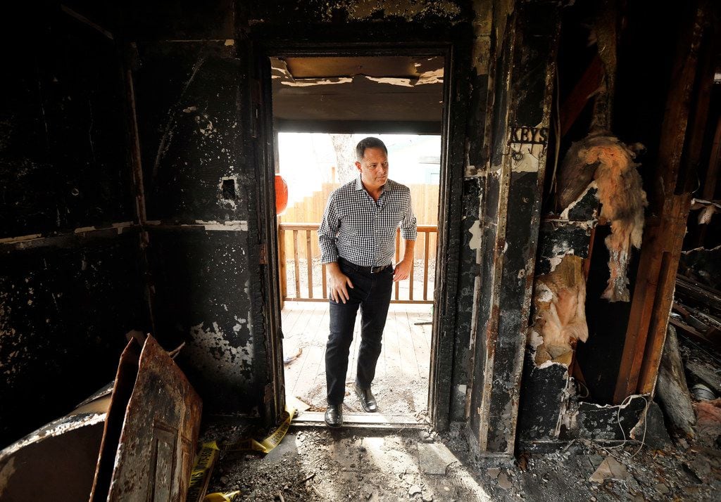Rep. Rafael Anchia steps inside a house on Durango Drive in Dallas that burned in a fire...