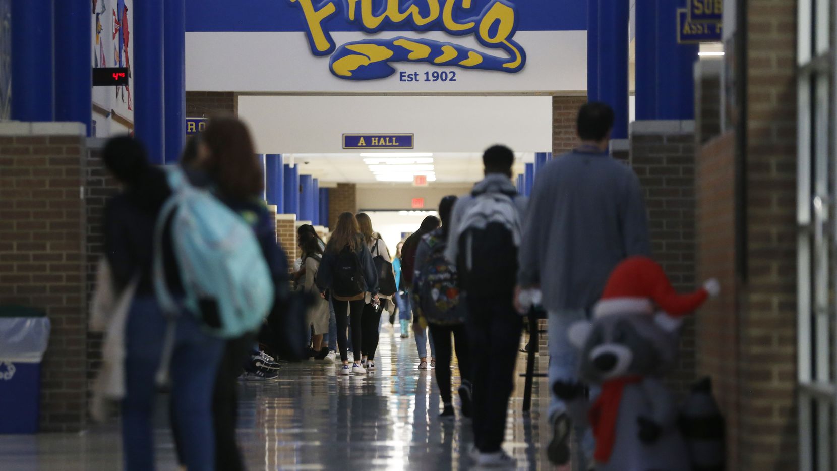 Students walk the halls at Frisco High School in Frisco, Texas on Thursday, December 13,...