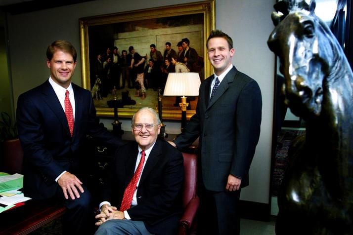 Lamar Hunt poses with his sons Clark (left) and Dan at the offices of Hunt Sports Group in...