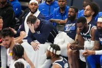 Dallas Mavericks guard Luka Doncic and guard Kyrie Irving sit on the bench during the second...