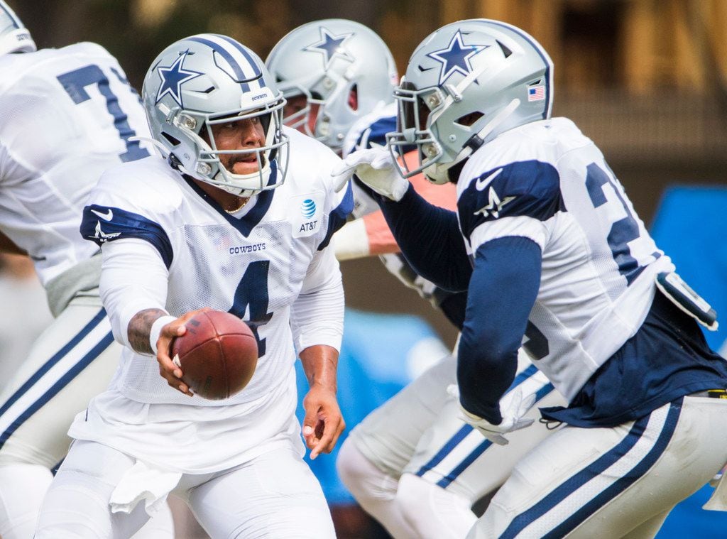 Dallas Cowboys quarterback Dak Prescott (4) hands off to running back Darius Jackson (26)...