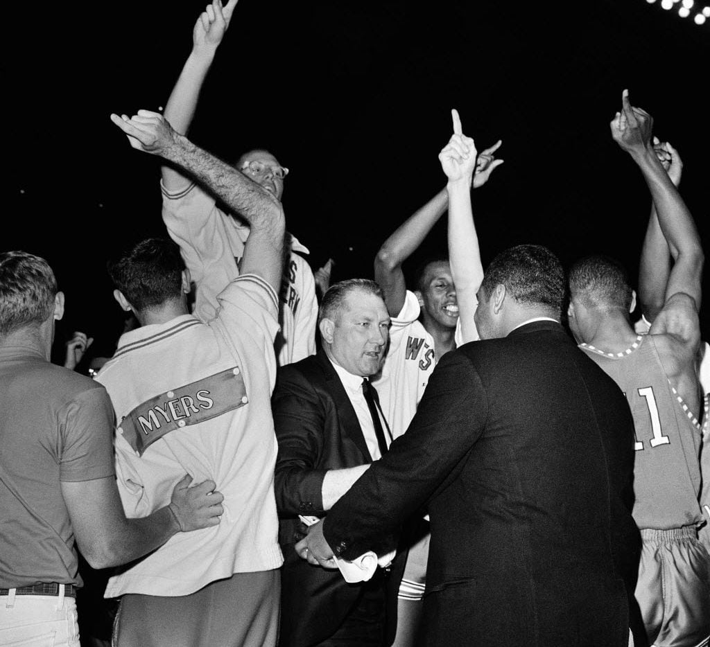FILE - In this March 20, 1966 file photo, Texas Western coach Don Haskins, center, is...