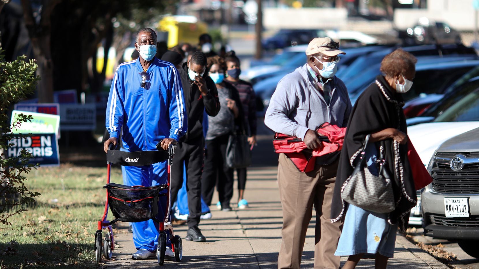 Voters in Oak Cliff wait to cast ballots on Oct. 13, the first day of early voting for the...