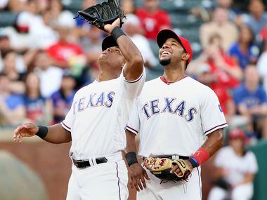 Texas Rangers shortstop Elvis Andrus (1) looks on as third baseman Adrian Beltre (29)...