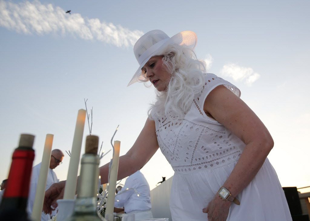 Penny Sanders sets the table during the inaugural Diner en Blanc Dallas on the Continental...