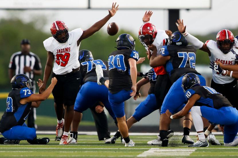A field goal attempt by North Forney’s Collin Randall (30) is blocked by Mesquite Horn’s...