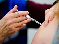 FILE - A health worker administers a dose of a COVID-19 vaccine during a vaccination clinic...